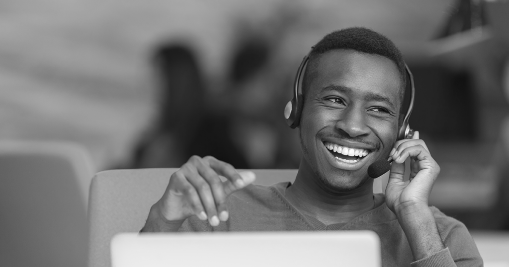 Call center operator smiling while on the phone.