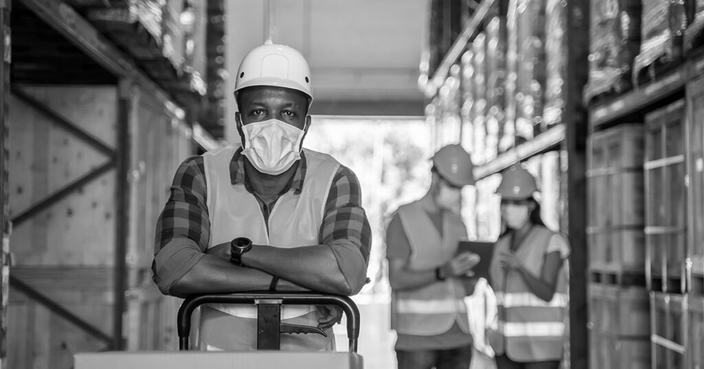 Ecommerce workers loading boxes in a warehouse.