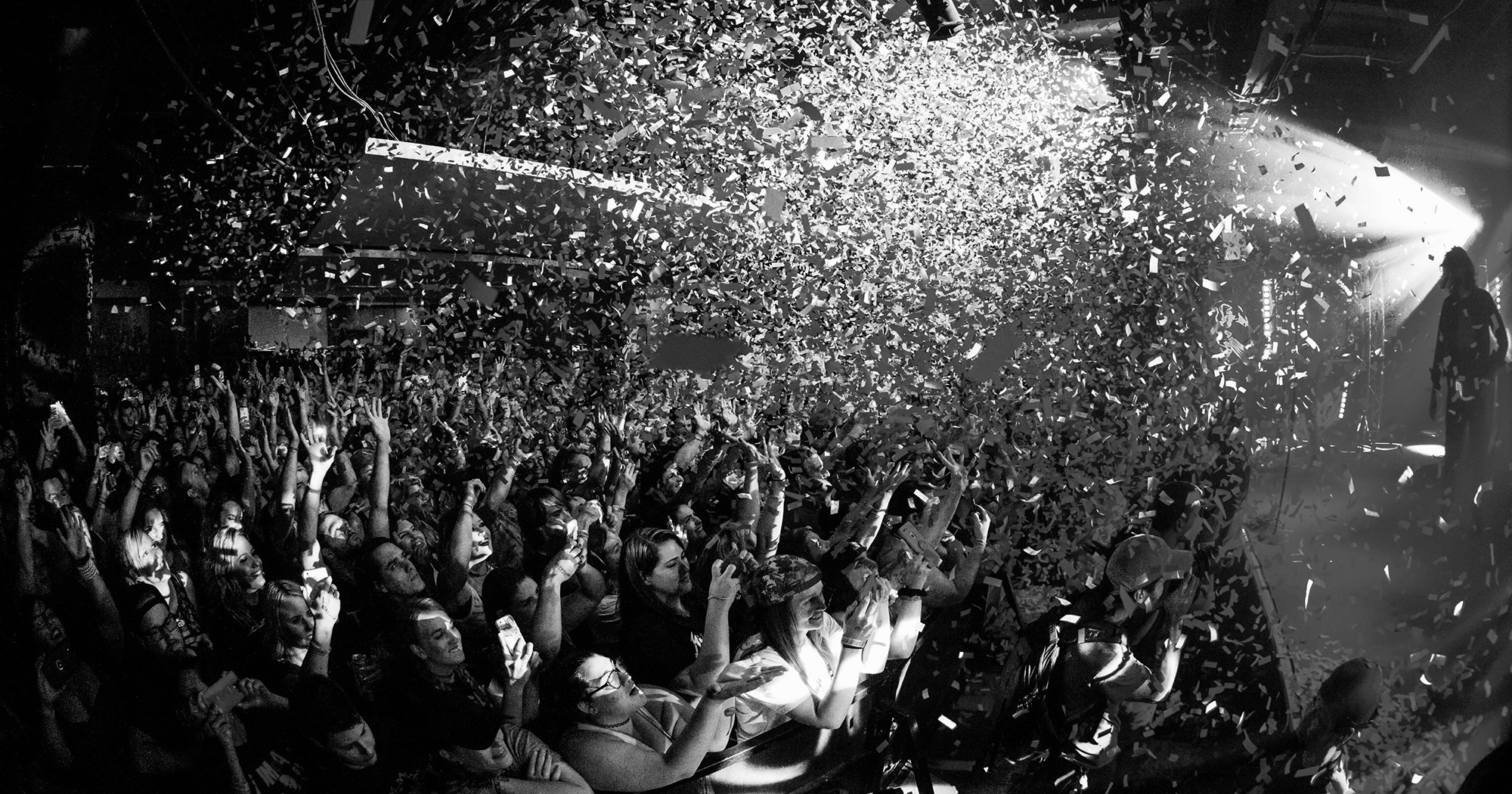 Musical event with confetti raining down on the crowd.
